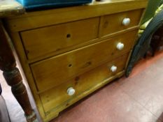 Pine chest of two short over two long drawers with white knobs (two missing)