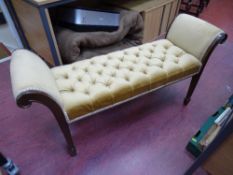 Vintage upholstered stool with scrolled ends and tapered supports