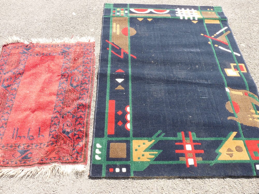 Modern geometric pattern rug and a red tasselled rug