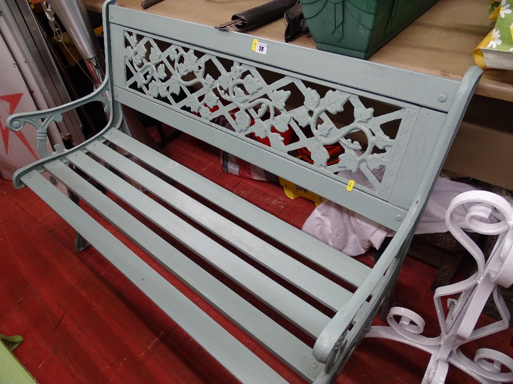 Painted wooden slatted garden bench with metal ends and floral decoration