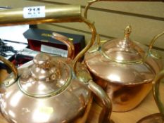 Two copper kettles, one with acorn knop