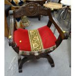 A carved oak ceremonial chair with cushioned seat