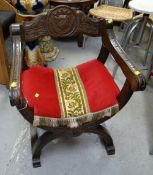 A carved oak ceremonial chair with cushioned seat