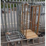 Two metal transport trolleys / cages on wheels (outside)