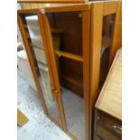 A modern teak wood two glass door display cabinet