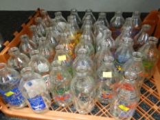 A crate of vintage advertising milk bottles