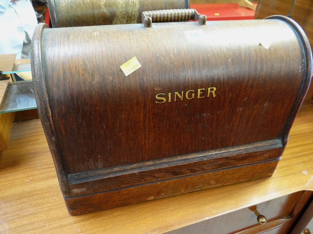 A vintage wooden cased Singer sewing machine