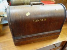 A vintage wooden cased Singer sewing machine
