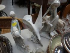 Lladro figure of a female milking a cow together with a Lladro figure of a seagull & Nao figure of a
