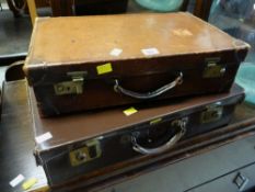 Two small vintage brown leather suitcases