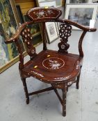 An Oriental hardwood inlaid decorated corner chair