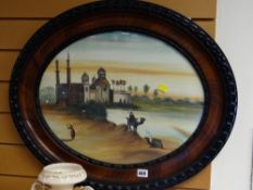 Vintage oval carved mahogany framed oil on card of a Middle Eastern riverbank scene