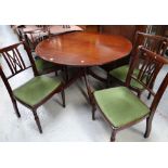 A good reproduction circular mahogany extending dining table together with four matching upholstered
