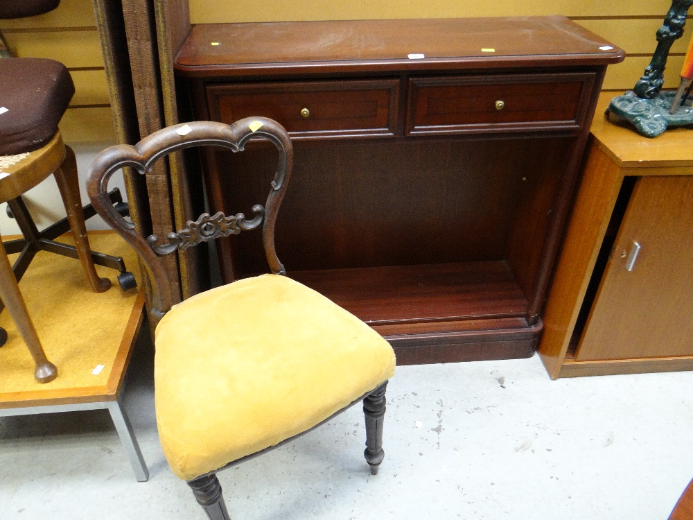 A modern dark wood two-drawer small bookcase together with a balloon back cushion seated chair