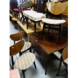 A vintage G-Plan dark wood drop leaf dining table together with four matching butterfly chairs