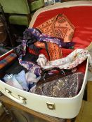 A vintage suitcase & contents including a selection of handbags & scarves