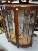 A vintage bow fronted mirror back display cabinet