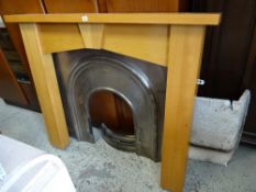 A modern light oak fire surround with metal insert