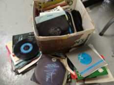 A box of single records from the 80s & 90s