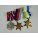 Three WWII medals in box with newspaper clipping
