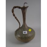 A Middle Eastern copper & etched decorated snake-handled ewer