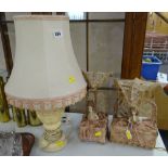 A pair of early twentieth century doll table lamps both 'sat up in bed' with silk bed-clothes and