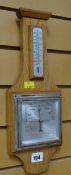A vintage light oak barometer / thermometer