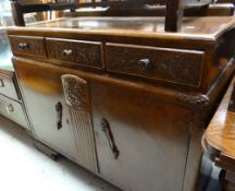 A vintage oak railback sideboard with carved decoration to drawers & centre panel
