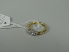 An 18ct gold three-stone diamond ring