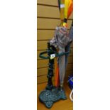 A green painted cast metal umbrella / stick stand & contents