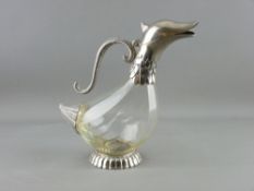 A DUCK SHAPED CLARET JUG with plated metal mounts, 25 cms high