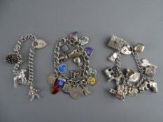 THREE SILVER CHARM BRACELETS, two with hallmarked padlock fasteners, thirty plus charms overall,
