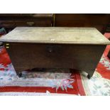 AN ANTIQUE OAK SWORD CHEST, seven plank construction with iron strap lock and pin hinges, 56.5 cms