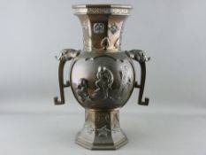 A JAPANESE MEIJI PERIOD BRONZE TWO HANDLED VASE with cartouche panels of figures in relief, 36.5 cms