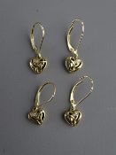 TWO PAIRS OF NINE CARAT GOLD HEART SHAPED EARRINGS in the Celtic style, each with two tiny diamonds,