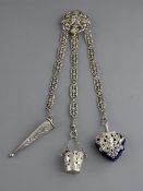 A CONTINENTAL WHITE METAL THREE STRAND CHATELAINE with scissor sleeve, bucket shaped thimble