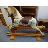 A HADDON OF WALLINGFORD ANTIQUE STYLE COMPOSITE ROCKING HORSE, finished in dapple colours with