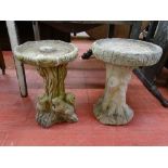 TWO RECONSTITUTED STONE BIRD BATHS on naturalistic bases, 54 and 57 cms high, 45 and 39 cms