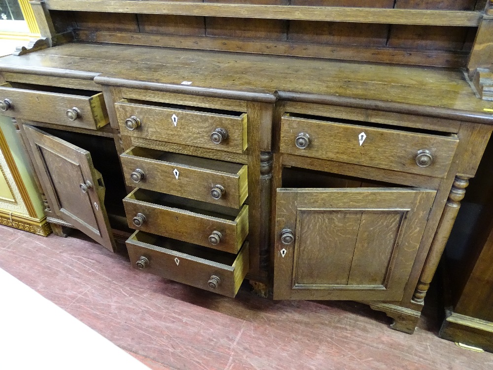A MID 19th CENTURY OAK WELSH DRESSER having a three shelf rack with turned end pillars and - Image 2 of 3