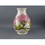 A MOORCROFT 'MAGNOLIA' 19 cms HIGH BULBOUS VASE decorated on a cream ground, factory stamps to the