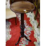 A VICTORIAN CARVED MAHOGANY TORCHERE, 89 cms high, 37 cms diameter top