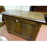 A NEAT REPRODUCTION CARVED OAK LIDDED BLANKET CHEST, 54 cms high, 76 cms wide, 45 cms deep