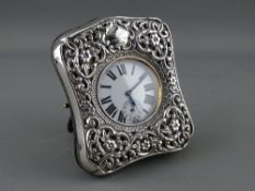 AN EDWARDIAN SILVER FRONTED WATCH STAND with easel back, Birmingham 1902 with white metal cased