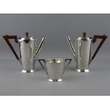 A SILVER THREE PIECE ART DECO COFFEE SET of two coffee pots with angular bakelite handles and