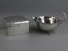 A SILVER THREE FOOTED SHALLOW CREAM JUG & A SILVER SQUARE CEDAR LINED CIGARETTE BOX, Sheffield 1905,