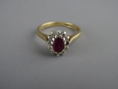 A LADY'S NINE CARAT GOLD CLUSTER RING having a small oval centre pink stone with twelve tiny