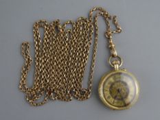 A FOURTEEN CARAT GOLD ENCASED BRIGHT CUT LADY'S FOB WATCH with decorative black and floral dial,