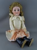 A SIMON & HALBIG GERMAN BISQUE HEADED DOLL with blue eyes, open mouth with teeth showing and painted