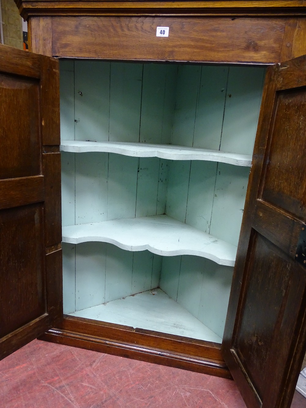 AN OAK TWO DOOR PANEL FRONT WALL HANGING CORNER CUPBOARD with shaped interior shelves, 111 cms high, - Image 2 of 2