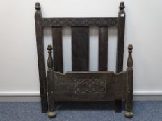 A PAIR OF JACOBEAN OAK STYLE SINGLE BED ENDS, 121 cms high, 91.5 cms wide the tallest